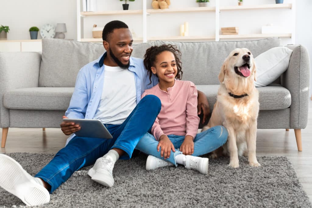 father and his daughter are watching TV