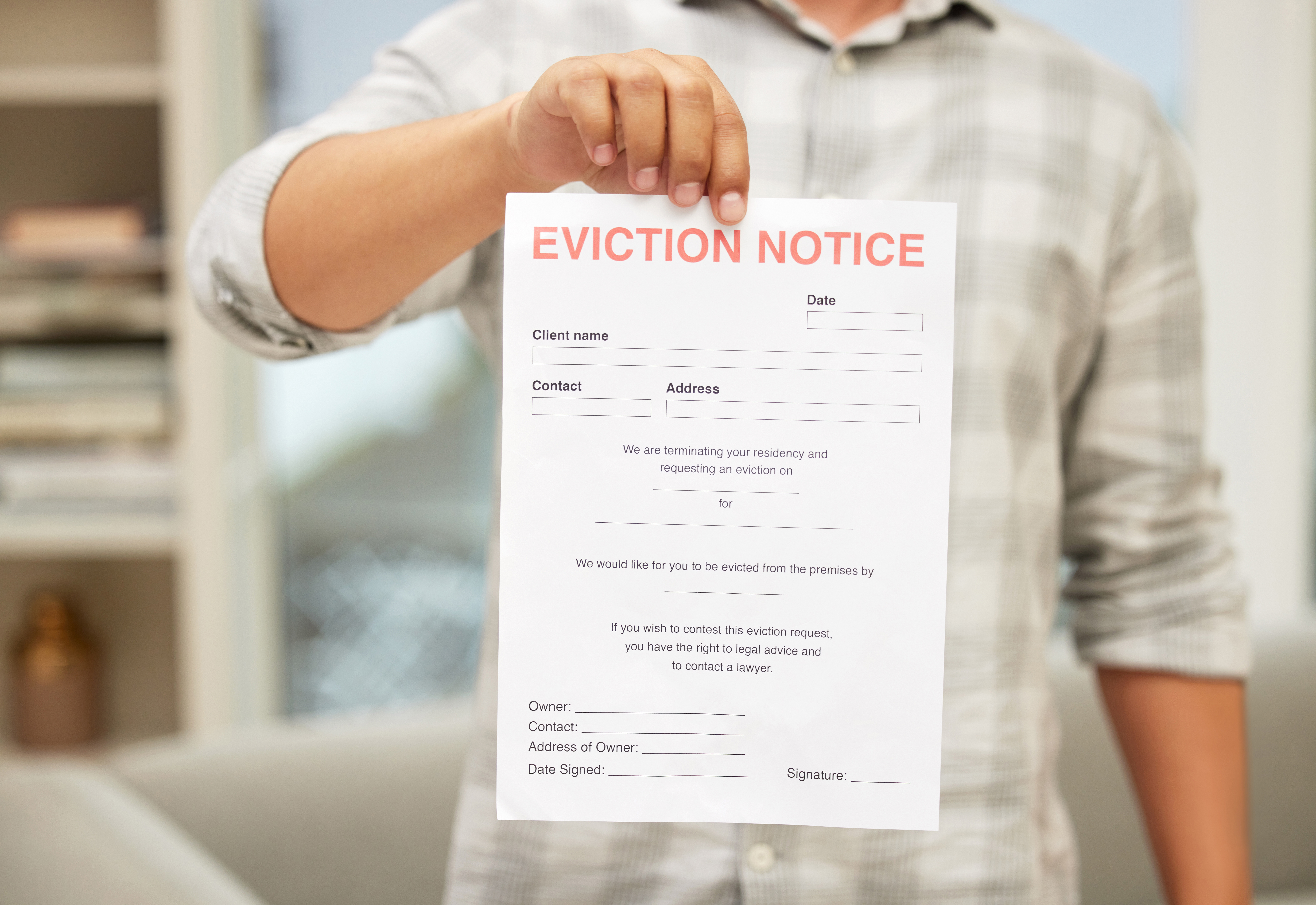Shot of an unrecognizable man holding an eviction notice