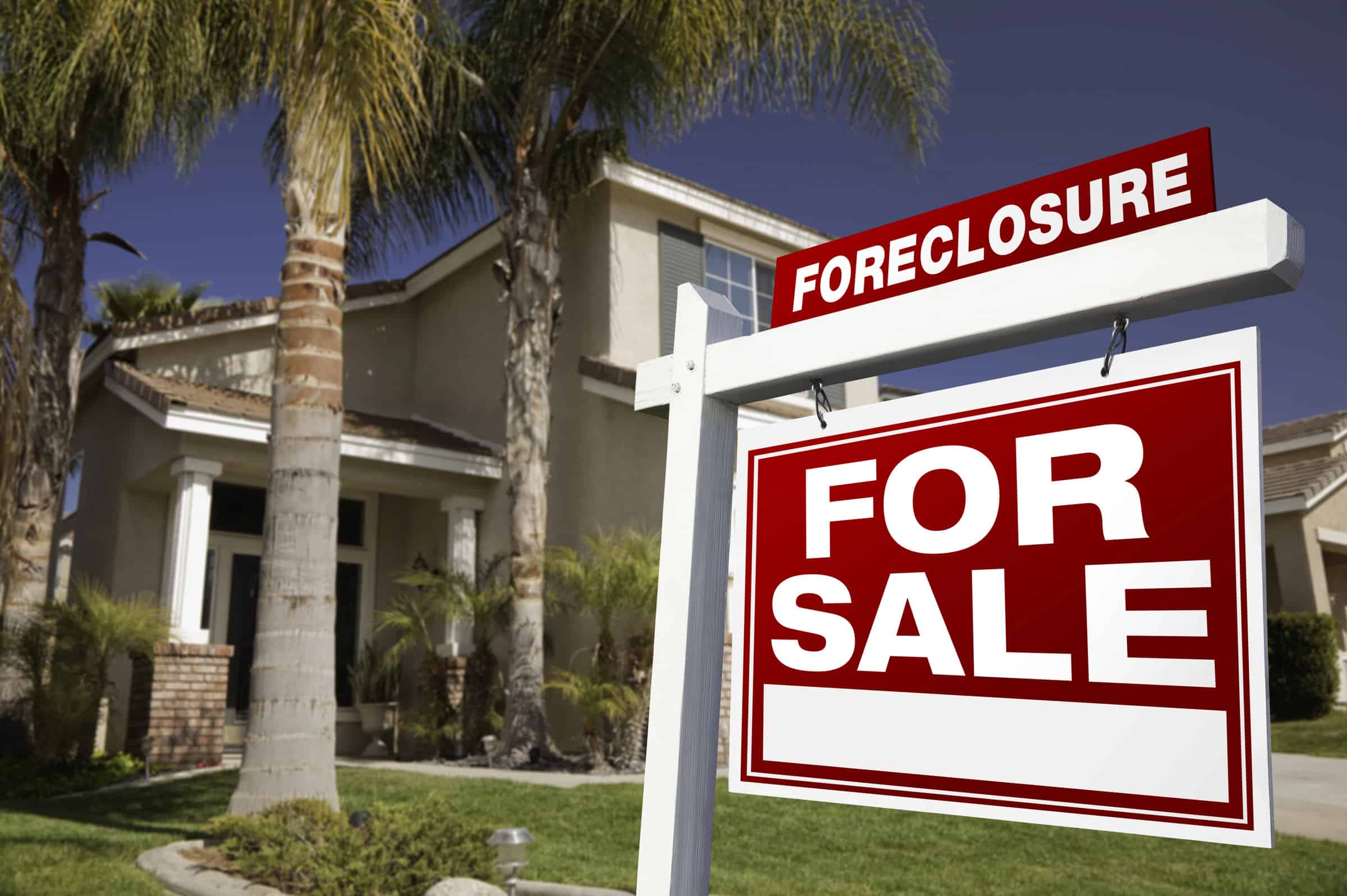 A For Sale sign with a Foreclosure notice stands in front of a two-story Florida home, highlighting the importance of protecting homeowners and lien foreclosure defense.